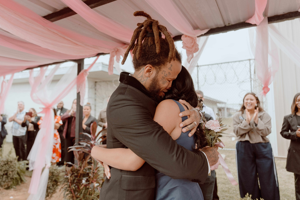 This photo provided by God Behind Bars shows a prisoner at the Louisiana State Penitentiary embracing a loved one before a father-daughter dance held inside the lockup in Angola, La., on Saturday, Nov. 22, 2025. (God Behind Bars via AP)