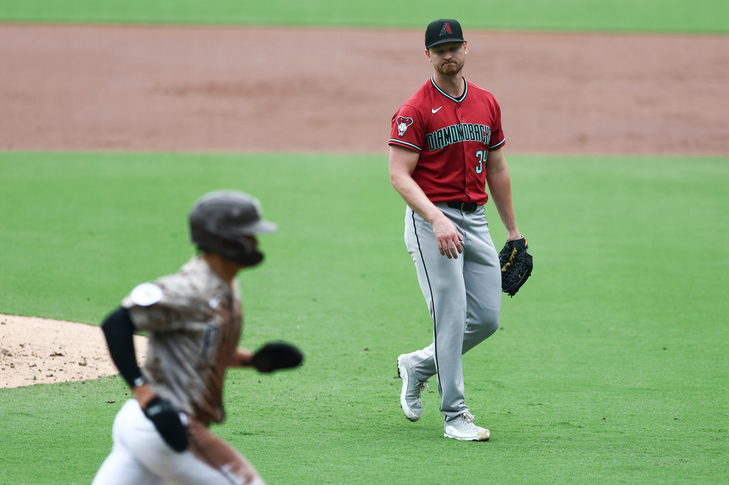 Arizona Diamondbacks manager Torey Lovullo pauses in the team dugout during the first inning of a baseball game against the New York Yankees, Friday, Sept. 18, 2026, in Phoenix. (AP Photo/Ross D. Franklin)
