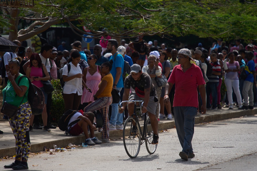 People wait to take public transportation during a blackout in Havana, Wednesday, March 4, 2026. (AP Photo/Ramon Espinosa)