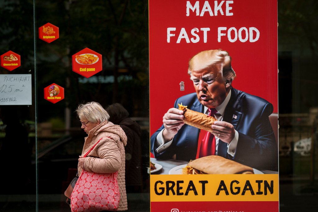 FILE - A poster depicts Donald Trump in the window of a closed fast food restaurant in Bucharest, Romania, May 13, 2024. (AP Photo/Vadim Ghirda, File)