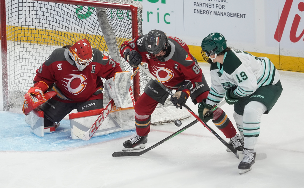 Ottawa Charge goalie Gwyneth Philips, left, looks on as teammate Ronja Savolainen (88) takes the puck away from Boston Fleet's Abby Newhook (19) during second-period PWHL hockey playoff action in Ottawa, Ontario, Friday, May 8, 2026. (Adrian Wyld/The Canadian Press via AP)