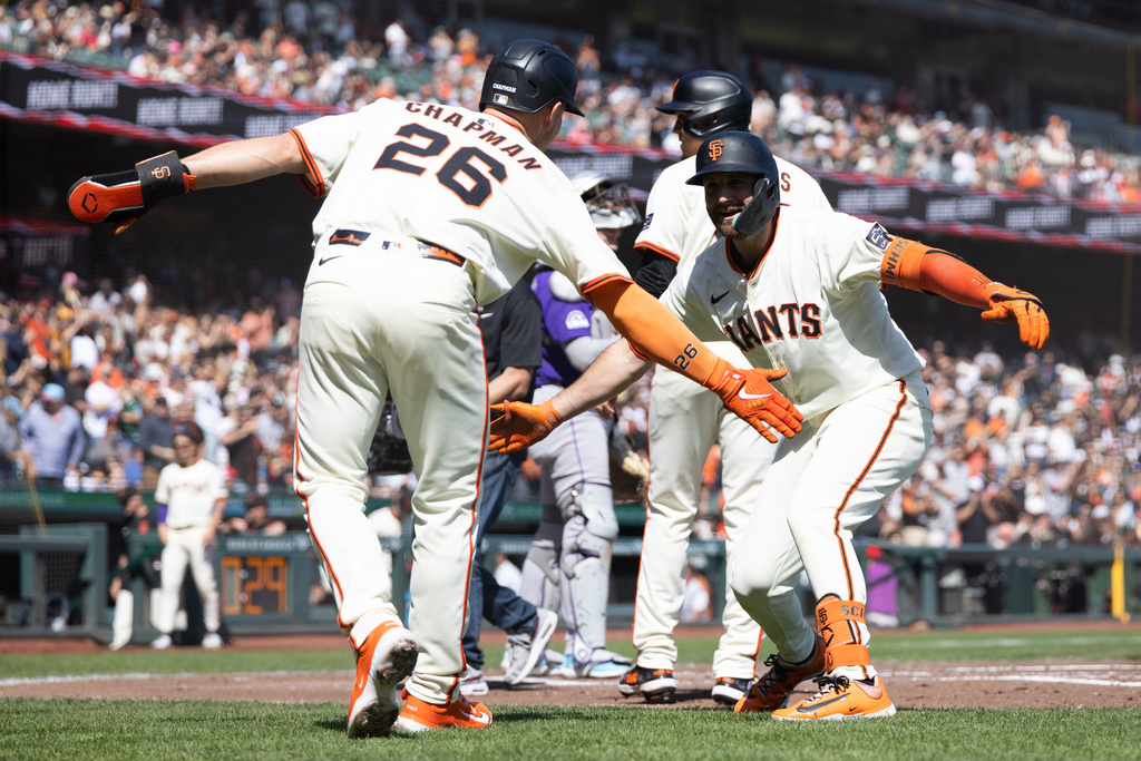 San Francisco Giants' Casey Schmitt celebrates a three-run home run with San Francisco Giants' Matt Chapman (26) during the second inning of an MLB baseball game against the Colorado Rockies, Saturday, Sept. 27, 2025, in San Francisco. (AP Photo/Benjamin Fanjoy)