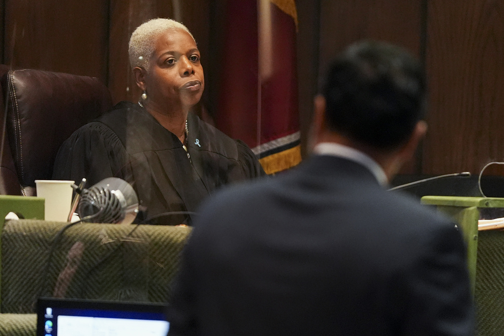 Judge Jennifer Johnson Mitchell, left, looks on as Manny Arora, the defense attorney for Hernandez Govan, the man accused of orchestrating the killing of rapper Young Dolph, asks a question to a witness during trial at in Memphis, Tenn., Wednesday, Aug. 20, 2025. (Chris Day/Commercial Appeal/USA Today Network via Pool)