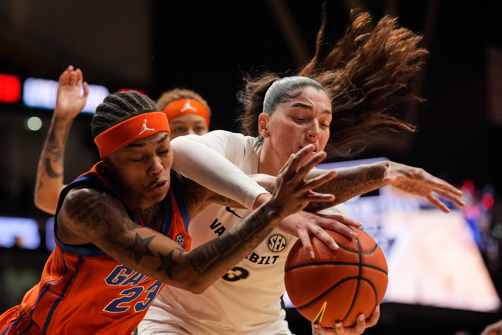 Florida guard Liv McGill (23) and Vanderbilt guard Justine Pissott (13) battle for a rebound during the first half of an NCAA college basketball game Sunday, Feb. 1, 2026, in Nashville, Tenn. (AP Photo/George Walker IV)