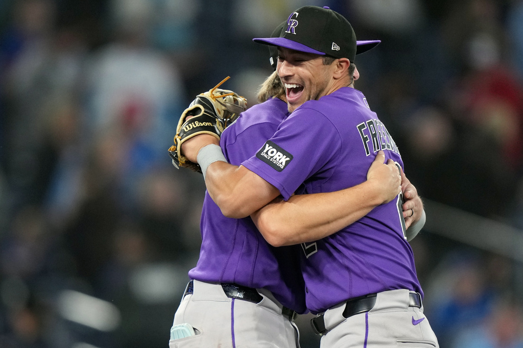 Colorado Rockies right fielder Tyler Freeman (2), right, and Colorado Rockies catcher Hunter Goodman (15) celebrate the win over the Toronto Blue Jays during tenth inning MLB baseball action in Toronto on Wednesday, April 1, 2026. (Nathan Denette/The Canadian Press via AP)