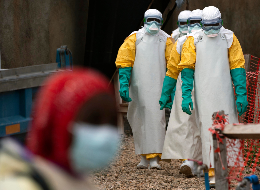 FILE - Health workers dressed in protective gear begin their shift at an Ebola treatment center in Beni, Congo, July 16, 2019. (AP Photo/Jerome Delay, File)
