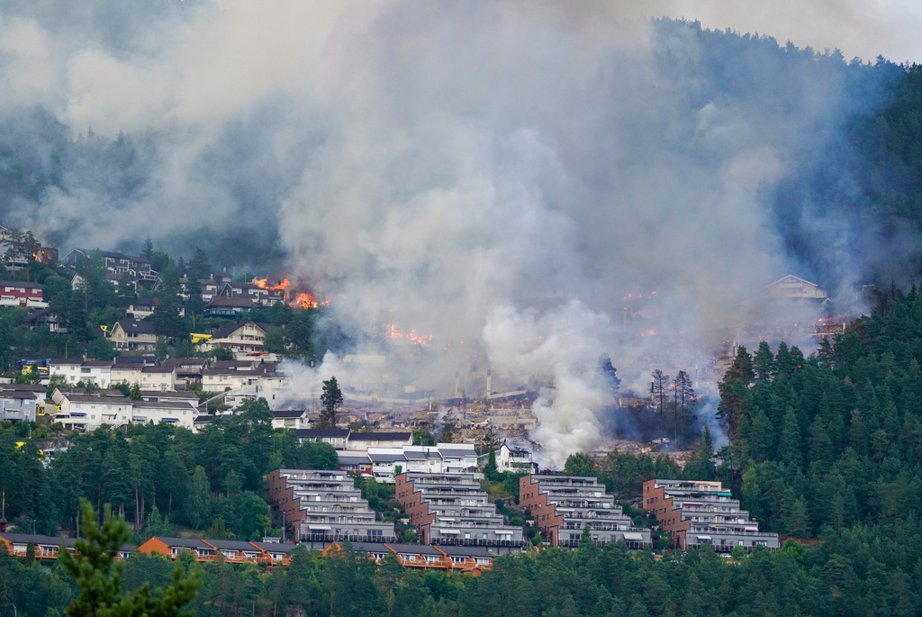Smoke rises over terraced houses on fire in the Krokstadelva village in Drammen, Norway, Friday. July 17, 2026. (Thomas Fure/NTB Scanpix via AP)
