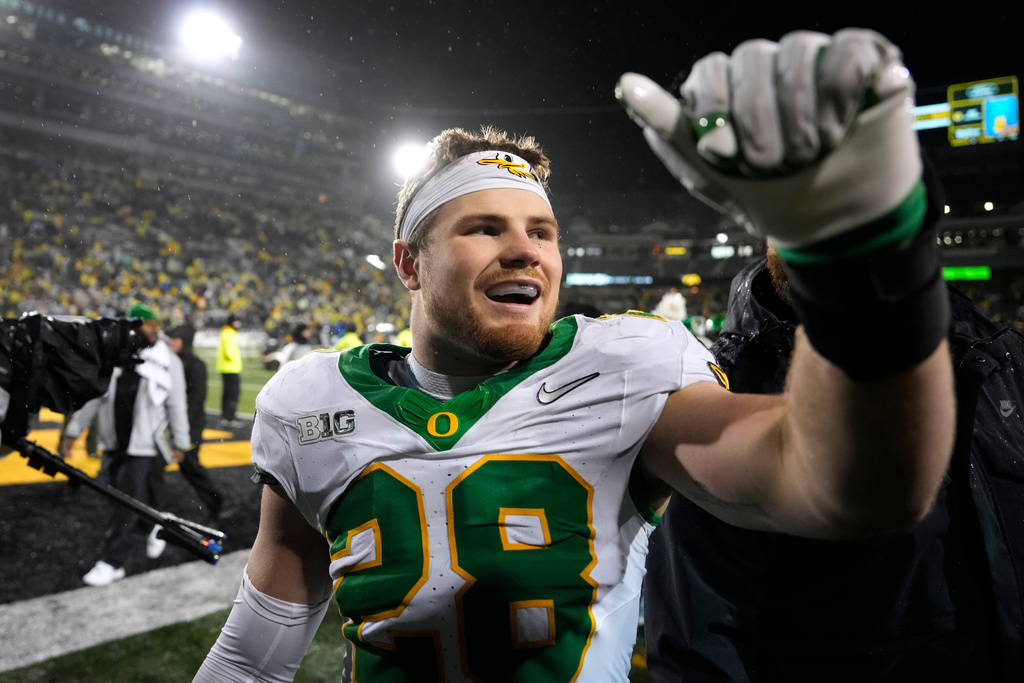 FILE - Oregon linebacker Bryce Boettcher (28) celebrates with fans after an NCAA college football game against Iowa, Nov. 8, 2025, in Iowa City, Iowa. (AP Photo/Charlie Neibergall, File)