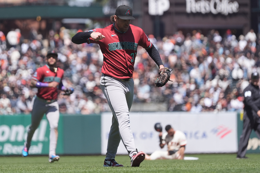 Arizona Diamondbacks pitcher Kevin Ginkel, middle, reacts after picking off San Francisco Giants' Luis Arraez, bottom rear, for the final out of the eighth inning of a baseball game Wednesday, May 27, 2026, in San Francisco. (AP Photo/Jeff Chiu)