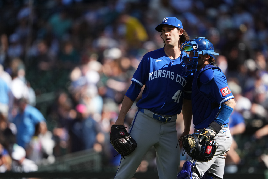 Kansas City Royals relief pitcher Daniel Lynch IV, left, greets catcher Carter Jensen, right, as they celebrate a win over the Seattle Mariners in a baseball game, Sunday, May 3, 2026, in Seattle. (AP Photo/Lindsey Wasson)