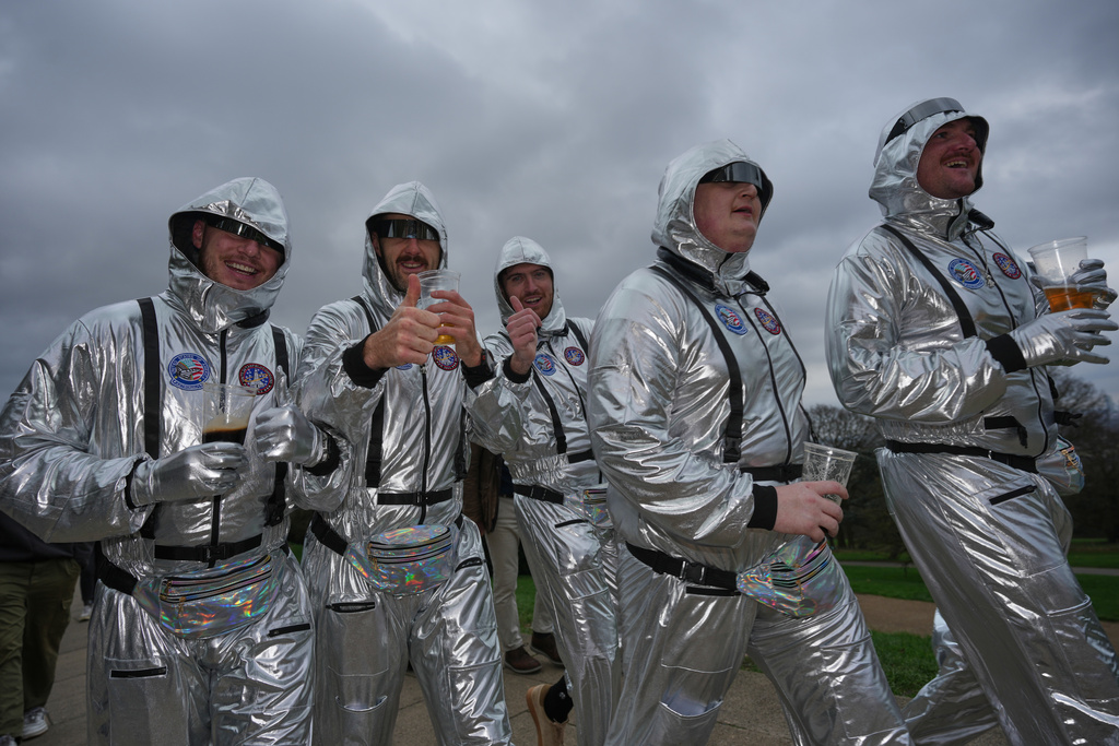 Darts fans arrive in costume to watch the World Darts Championships at Alexandra Palace in London, Monday, Dec. 15, 2025. (AP Photo/Kin Cheung)
