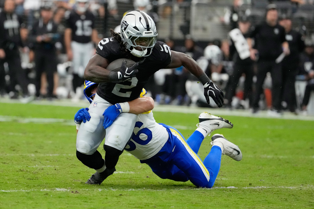 Los Angeles Rams safety Maximus Pulley, right, tackles Las Vegas Raiders running back Ashton Jeanty during the first half of an NFL football game Sunday, Oct. 25, 2026, in Las Vegas. (AP Photo/John Locher)
