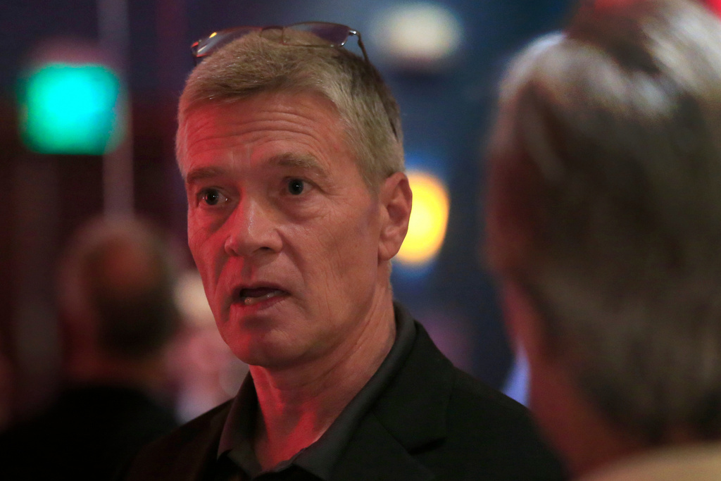 FILE - Republican 3rd district congressional candidate Greg Goode talks with supporters at a Johnson County Republican election watch party in Overland Park, Kan., Aug. 2, 2016. (AP Photo/Orlin Wagner, File)