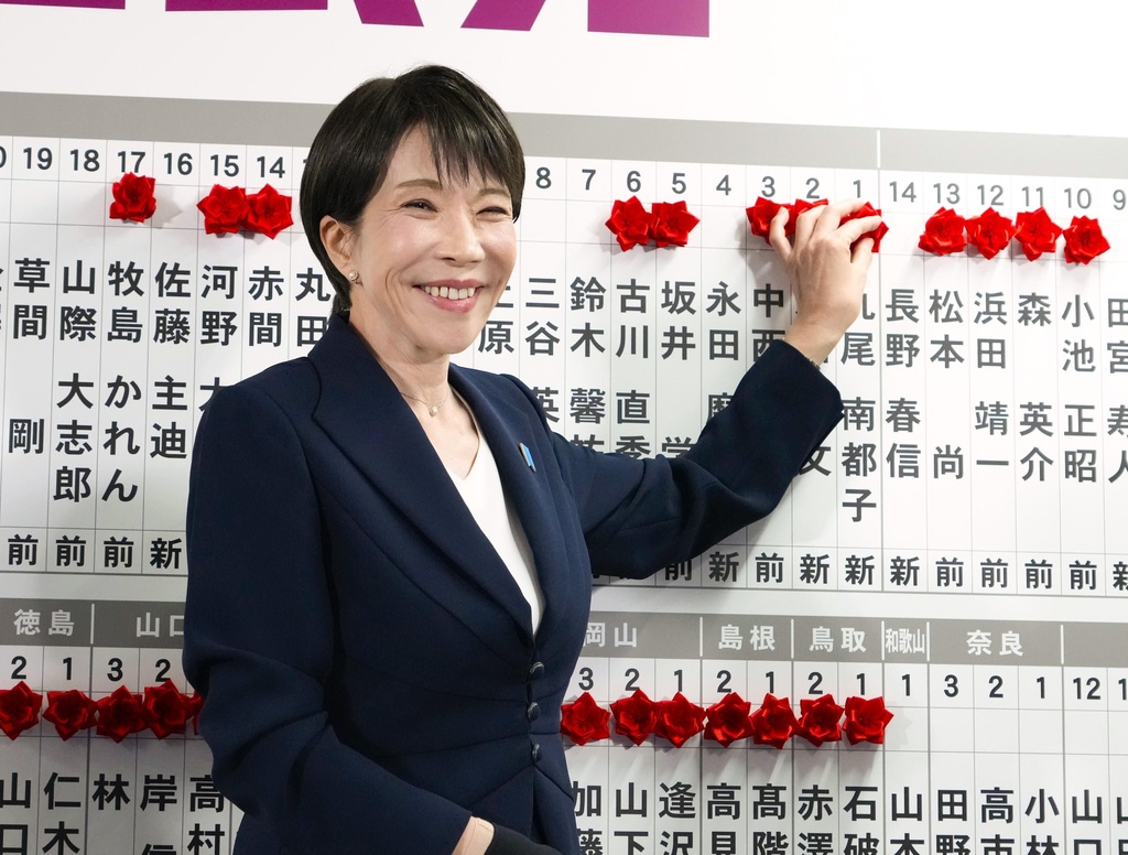 Sanae Takaichi, Japan's prime minister and president of the ruling Liberal Democratic Party (LDP), puts pins marking the names of candidates who won lower house elections at the LDP headquarters Sunday, Feb. 8, 2026 in Tokyo. (Keisuke Hosojima/Kyodo News via AP)