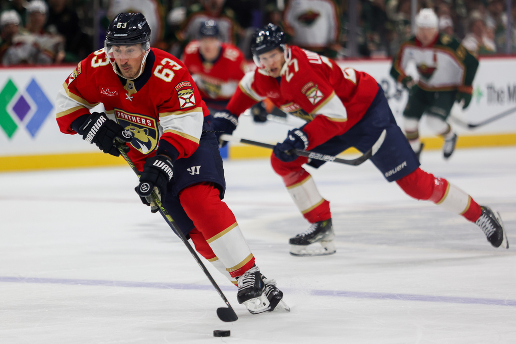 FILE - Florida Panthers' Brad Marchand (63) controls the puck against the Minnesota Wild during the second period of an NHL hockey game Jan. 24, 2026, in St. Paul, Minn. (AP Photo/Lily Dozier, File)