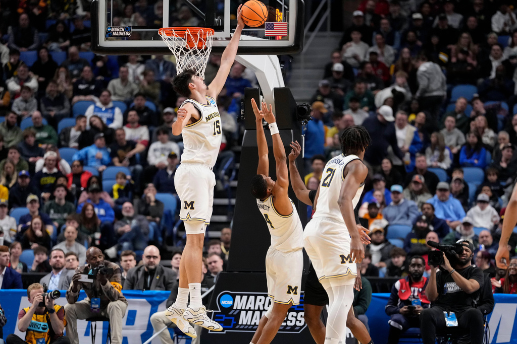 Michigan center Aday Mara (15) blocks Howard guard Bryce Harris during the second half in the first round of the NCAA college basketball tournament, Thursday, March 19, 2026, in Buffalo, N.Y. (AP Photo/Yuki Iwamura)
