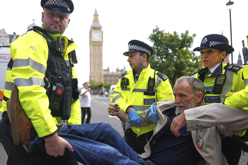 Police officers carry a protester during a protest to support Palestine Action in London, Saturday, Sept. 6, 2025.(AP Photo/Joanna Chan)
