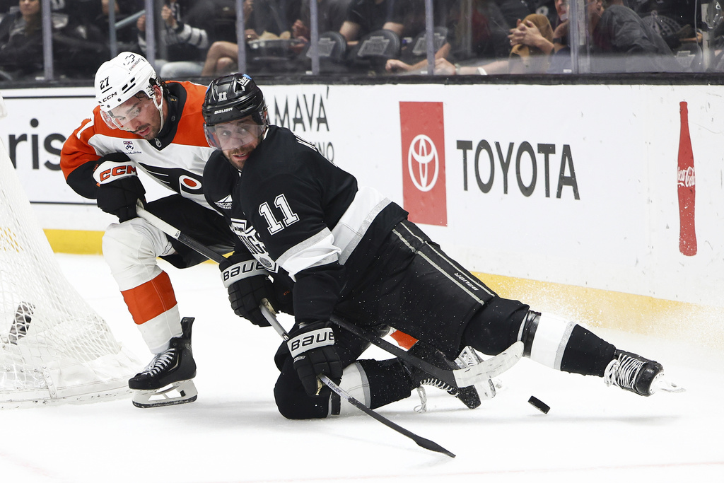 Los Angeles Kings center Anze Kopitar (11) and Philadelphia Flyers left wing Noah Cates, left, battle for the puck during the second period of an NHL hockey game, Thursday, March 19, 2026, in Los Angeles. (AP Photo/Jessie Alcheh)