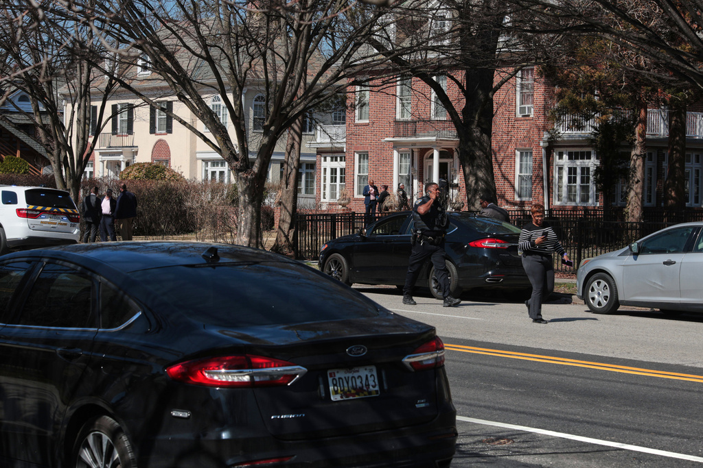 Investigators are seen near the scene of a shooting Tuesday, March 10, 2026, in Baltimore. (AP Photo/KT Kanazawich)