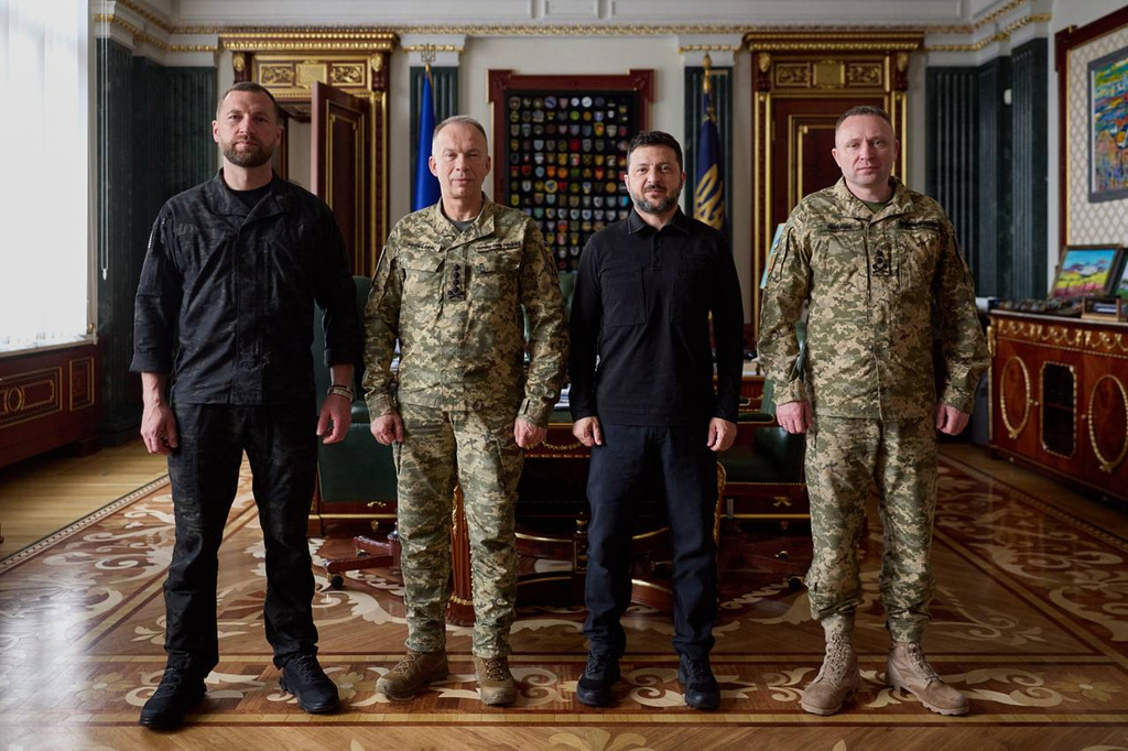 In this photo provided by the Ukrainian Presidential Press Office, from left, acting Minister of Defense Major General Yevhen Khmara, former Commander-in-Chief of the Ukrainian Armed Forces Oleksandr Syrskyi, Ukrainian President Volodymyr Zelenskyy and new commander-in-chief of Ukraine's Armed Forces Mykhailo Drapatyi, pose for a photo during their meeting in Kyiv, Ukraine, Wednesday, July 22, 2026. (Ukrainian Presidential Press Office via AP)