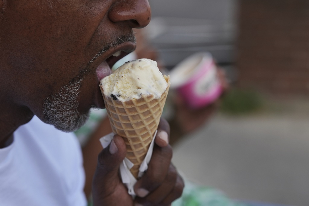 A person eats ice cream Friday, Sept. 5, 2025, in Cincinnati. (AP Photo/Joshua A. Bickel)