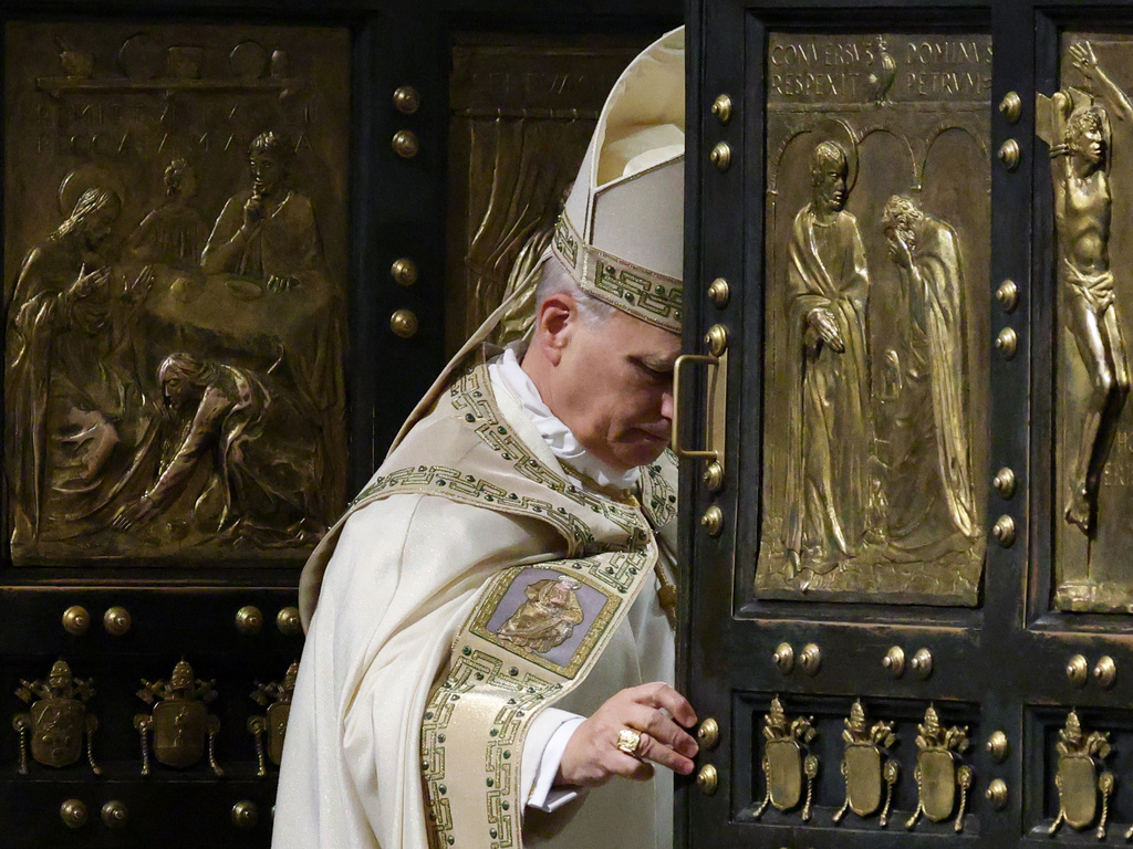Pope Leo XIV closes St. Peter's Basilica Holy Door to end the 2025 ordinary Jubilee year, at the Vatican, Tuesday, Jan. 6, 2026. (Yara Nardi/Pool photo via AP)