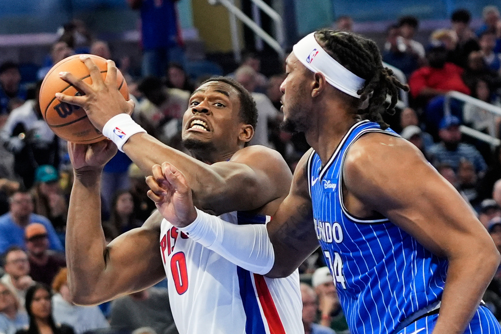 Detroit Pistons center Jalen Duren (0) goes to the basket against Orlando Magic center Wendell Carter Jr., right, during the first half of an NBA basketball game, Sunday, March 1, 2026, in Orlando, Fla. (AP Photo/John Raoux)