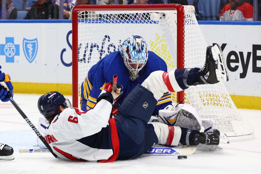 Washington Capitals defenseman Jakob Chychrun (6) is stopped by Buffalo Sabres goaltender Ukko-Pekka Luukkonen (1) during the second period of an NHL hockey game Saturday, Nov. 1, 2025, in Buffalo, N.Y. (AP Photo/Jeffrey T. Barnes)