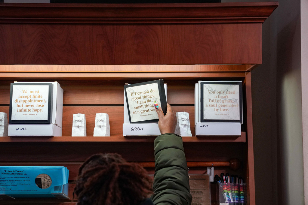 Keisha Burse looks at items for sale at Martin Luther King Jr. National Historical Park, Tuesday, Dec. 9, 2025, in Atlanta. (AP Photo/Megan Varner)