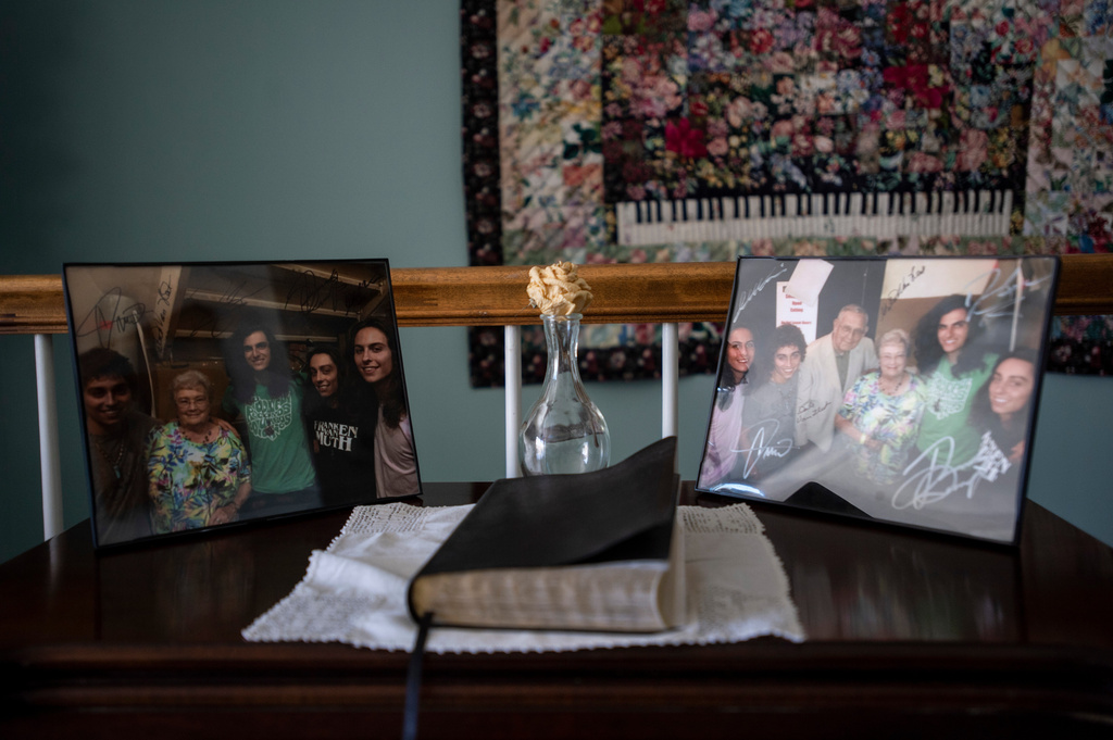 Photographs of the band Greta Van Fleet with Gretna Van Fleet and her husband sit on a desk at her home in Frankenmuth, Mich, Monday, Jan. 14, 2019. (Kaytie Boomer/Saginaw News via AP)