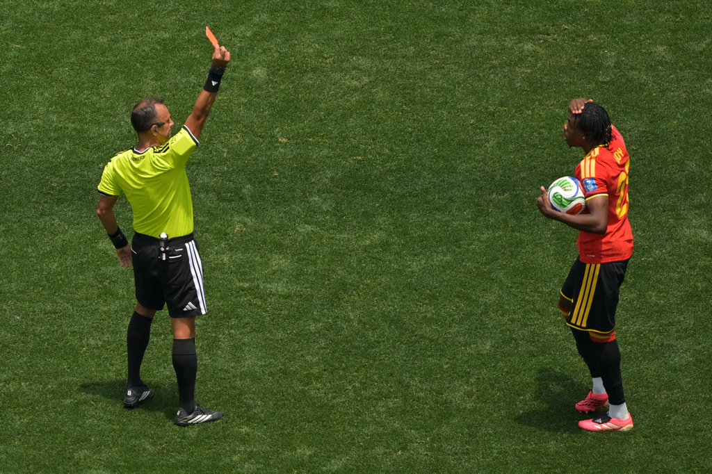 Referee Dario Herrera shows a red card to Belgium's Nathan Ngoy (25) during the World Cup Group G soccer match between Belgium and Iran in Inglewood, Calif., near Los Angeles, Sunday, June 21, 2026. (AP Photo/Jayne Kamin-Oncea)