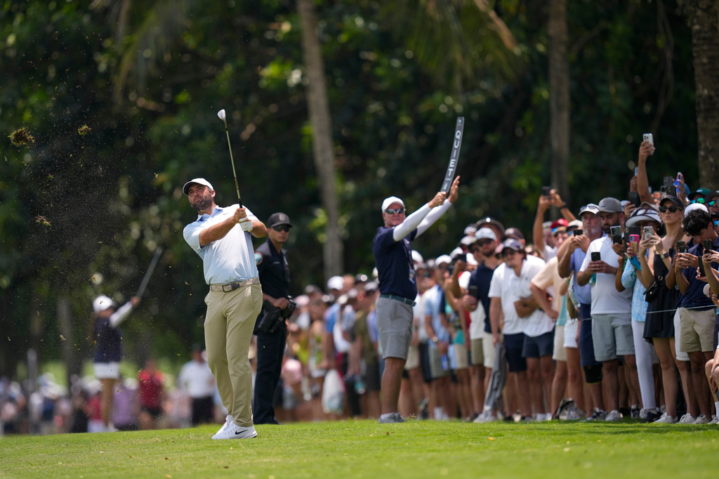 Scottie Scheffler hits from the first fairway during the third round of the Cadillac Championship PGA golf tournament Saturday, May 2, 2026, in Doral, Fla. (AP Photo/David J. Phillip)