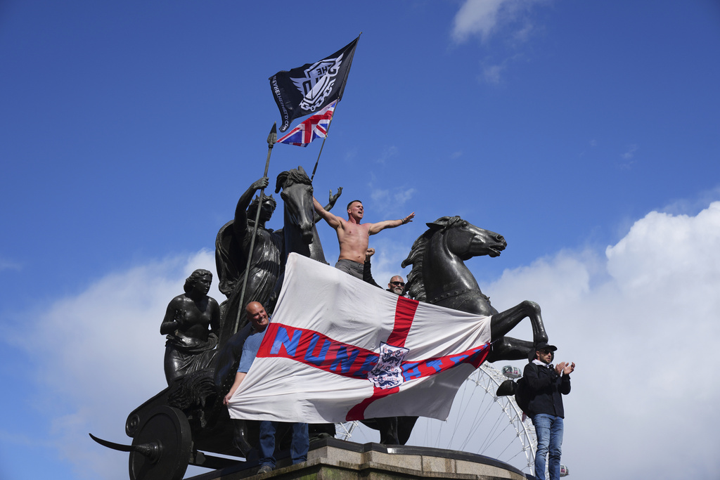 People demonstrate during the Tommy Robinson-led Unite the Kingdom march and rally, in London(AP Photo/Joanna Chan)