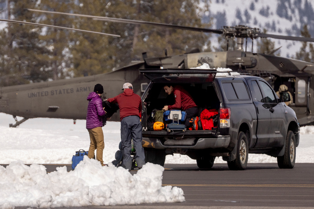 Emergency responders unload equipment from a truck at Truckee Airport, as efforts continue to recover the bodies of skiers who died during an avalanche, in Truckee, Calif., Saturday, Feb. 21, 2026. (Stephen Lam/San Francisco Chronicle via AP)