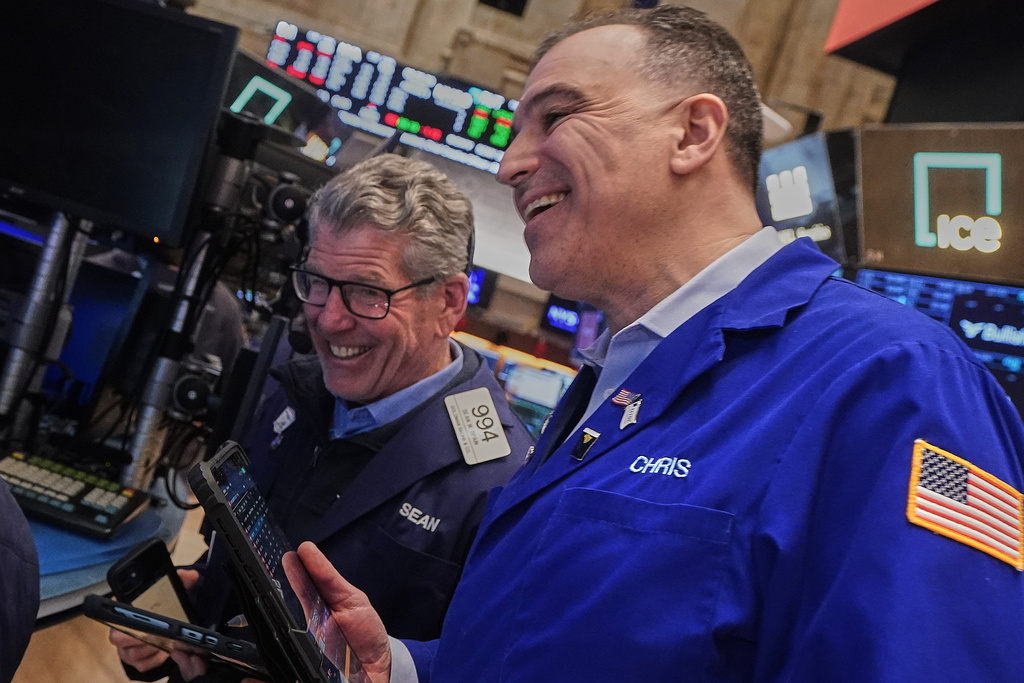 Traders Sean Spain, left, and Chris Lagana work on the floor of the New York Stock Exchange, Tuesday, Feb. 3, 2026. (AP Photo/Richard Drew)