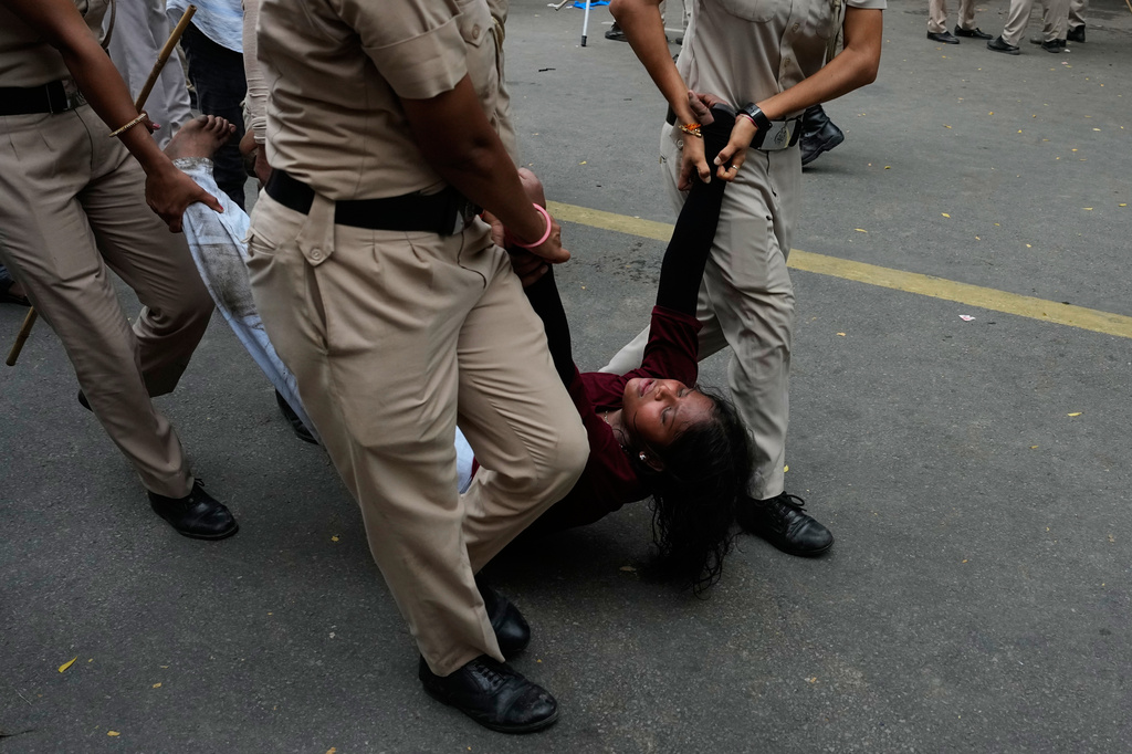 Police detain a supporter of the Cockroach Janta Party as they attempt to march toward India's Parliament, demanding the resignation of the education minister, in New Delhi, India, Monday, July 20, 2026.(AP Photo/Manish Swarup)