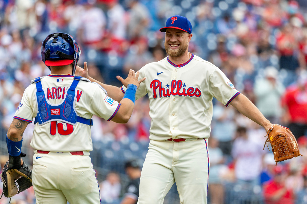 Philadelphia Phillies closing pitcher Jonathan Bowlan, right, and catcher Rafael Marchán, left, celebrate after their team's win over the Chicago White Sox in a baseball game, Sunday, June 7, 2026, in Philadelphia. (AP Photo/Laurence Kesterson)