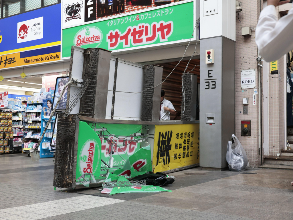 A store sign of a restaurant is seen fallen on the ground after an earthquake in Kumamoto in the Kyushu island, southern Japan, Tuesday, July 28, 2026. (Kyodo News via AP)