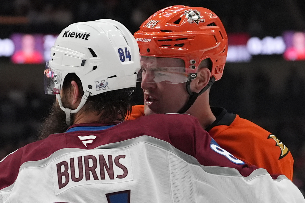 Colorado Avalanche defenseman Brent Burns (84) and Anaheim Ducks left wing Ross Johnston exchange words during the first period of an NHL hockey game Tuesday, March 3, 2026, in Anaheim, Calif. (AP Photo/Gregory Bull)
