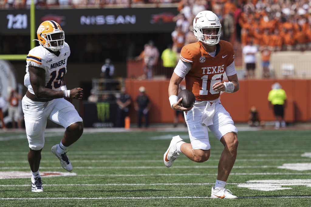 Texas quarterback Arch Manning (16) runs past UTEP defensive lineman Ashaad Hall (19) during the first half of an NCAA college football game in Austin, Texas, Saturday, Sept. 13, 2025. (AP Photo/Eric Gay)