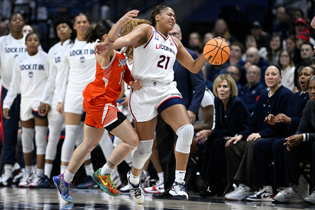 UConn forward Sarah Strong (21) is pressured by Syracuse guard Angelica Velez (15) during the first half in the second round of the NCAA college basketball tournament, Monday, March 23, 2026, in Storrs, Conn. (AP Photo/Jessica Hill)