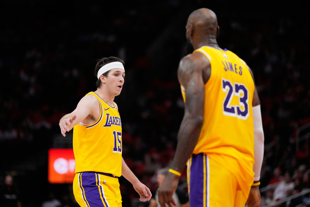 Los Angeles Lakers guard Austin Reaves (15) celebrates with forward LeBron James (23) during the second half of Game 6 of a first-round NBA playoffs basketball series against the Houston Rockets in Houston, Friday, May 1, 2026. (AP Photo/Ashley Landis)