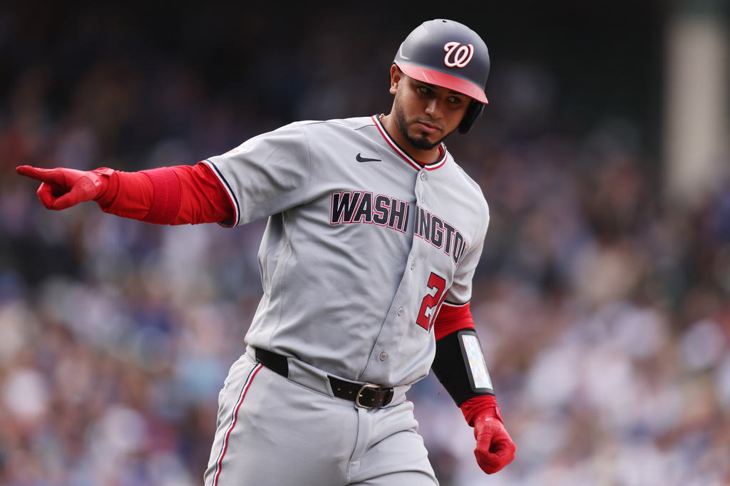 Washington Nationals Keibert Ruiz (20) celebrates hitting a two-run home run during the eighth inning of a baseball game against the Chicago Cubs at Wrigley Field on Sunday, March 29, 2026, in Chicago. (AP Photo/Geoff Stellfox)