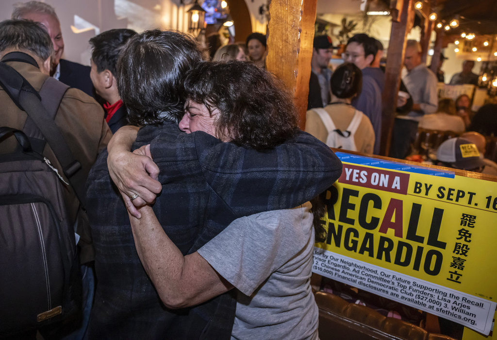Jennifer Dougherty hugs Otto Pippenger as supporters of Measure A campaign gathered to hear results of the measure to recall Supervisor Joel Engardio at Celia's restaurant in San Francisco, on Tuesday, Sept. 16, 2025. (Carlos Avila Gonzalez/San Francisco Chronicle via AP)