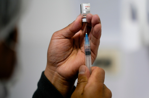 FILE - A healthcare worker prepares a shot of the Pfizer COVID-19 vaccine in La Paz, Bolivia, Jan. 7, 2025. (AP Photo/Juan Karita, File) FILE - A healthcare worker prepares a shot of the Pfizer COVID-19 vaccine in La Paz, Bolivia, Jan. 7, 2025. (AP Photo/Juan Karita, File)
