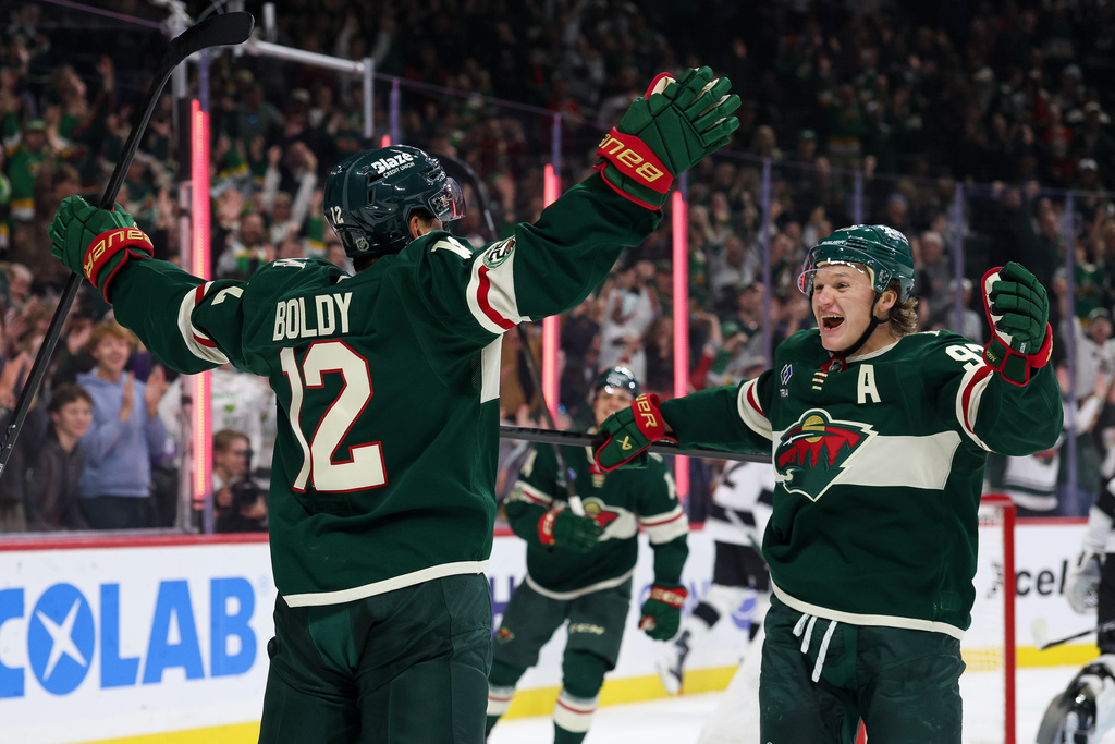 Minnesota Wild left wing Matt Boldy, left, celebrates after a goal with left wing Kirill Kaprizov, right, during the first period of an NHL hockey game against the Los Angeles Kings, Monday, Oct. 13, 2025, in St. Paul, Minn. (AP Photo/Matt Krohn)