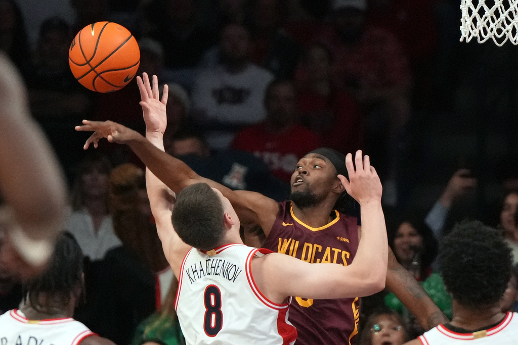 Bethune-Cookman guard Jakobi Heady, top right, blocks a shot byon Arizona forward Ivan Kharchenkov (8) during the first half of an NCAA college basketball game, Monday, Dec. 22, 2025, in Tucson, Ariz. (AP Photo/Rick Scuteri)