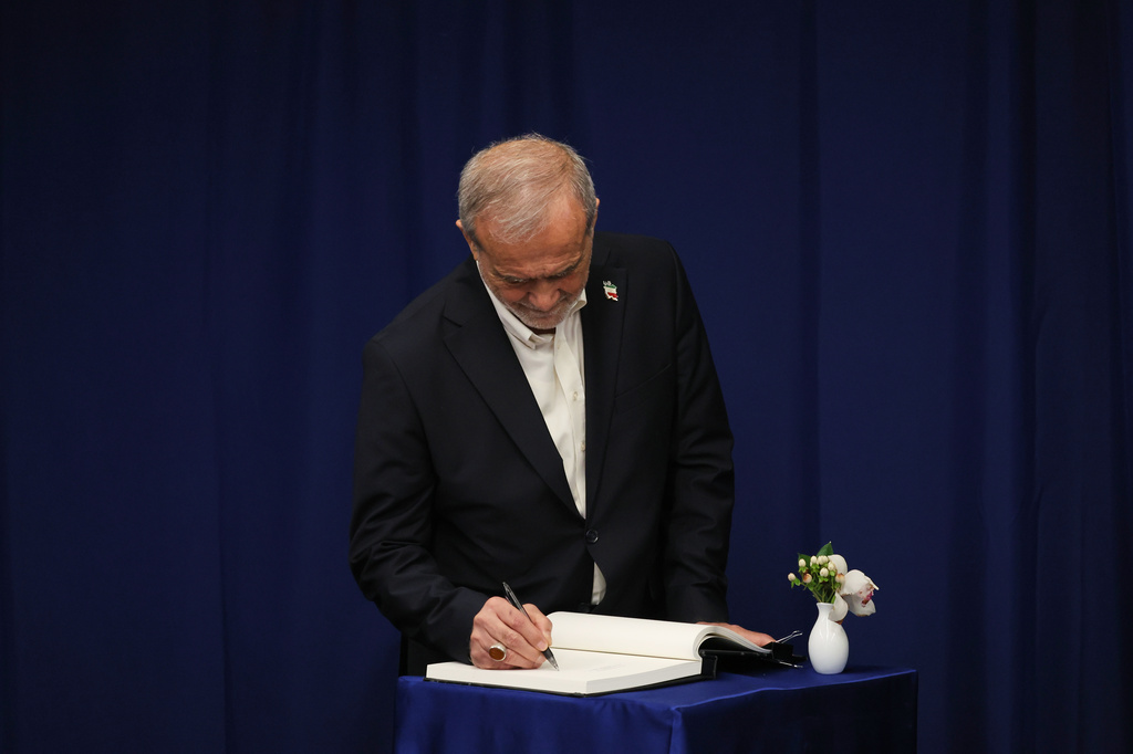 Iran's President Masoud Pezeshkian signs a book before meeting with United Nations Secretary-General Antonio Guterres at United Nations headquarters during the 81st session of the United Nations General Assembly, Friday, Sept. 25, 2026. (AP Photo/Heather Khalifa)