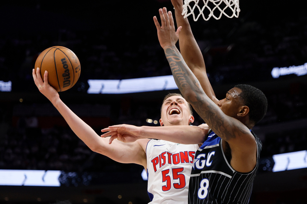Detroit Pistons forward Duncan Robinson (55) goes to the basket against Orlando Magic forward Jamal Cain (8) during the first half in Game 2 of a first-round NBA basketball playoffs series Wednesday, April 22, 2026, in Detroit. (AP Photo/Duane Burleson)