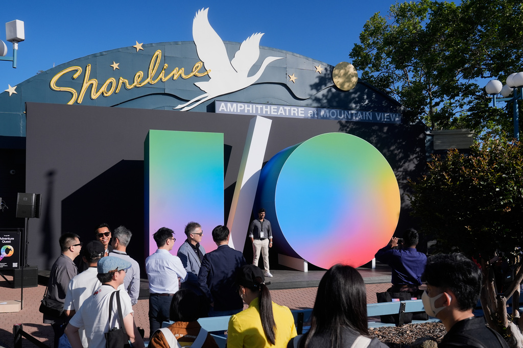 Attendees pose for photos before the keynote presentation at a Google I/O event in Mountain View, Calif., Tuesday, May 19, 2026. (AP Photo/Jeff Chiu)